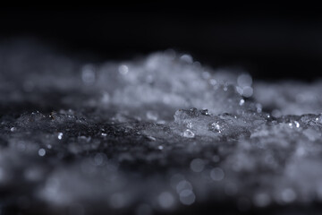 Snow and ice close-up on a dark background. Abstract winter background.