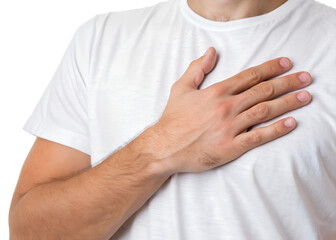 Close-up of a young man holding his hands on his heart during a professional physiotherapy treatment for health and body care