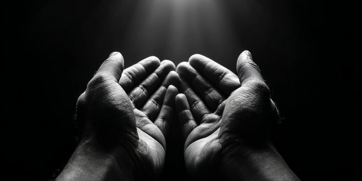 Black and white photography of open hands begging for mercy and help