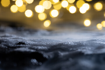 Close-up of snow and ice against a bokeh background. Abstract New Year's background.