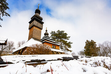 uzhhorod, ukraine - 15 jan 2017: old wooden church of archangel michael in open air museum of folk and architecture in winter. traditional wooden architecture of transcarpathia. heritage of ukraine