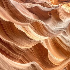 Obraz premium Intricate sandstone waves. Close-up view of swirling, pale orange and beige sandstone formations