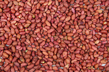 Brown peanuts on a white marble table. Food is healthy agricultural products.