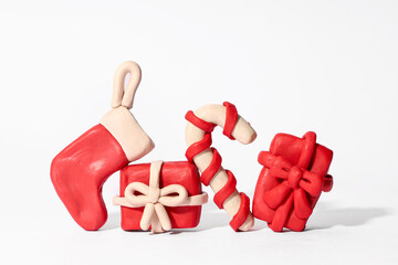 Christmas crafts made from plasticine on a white background. Christmas Set: Gifts, Christmas Stocking, Candy Cane