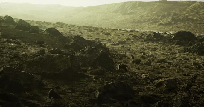 An expansive barren terrain covered in rocks and pebbles stretches under a muted sky. The lighting casts a surreal glow, evoking an otherworldly atmosphere at twilight.