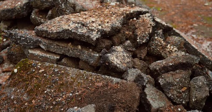 A heavy piece of rubble drops onto an existing debris pile, creating a dynamic impact shot with detailed textures and motion.