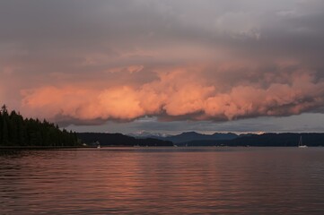 Waterfront sunset landscape with colorful cloudscape reflection