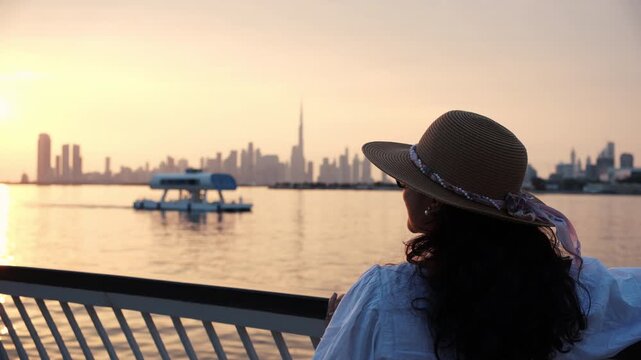 Dubai skyline silhouette at sunset with luxury yacht in creek, Pro res 422 Dubai skyline stock video download	 