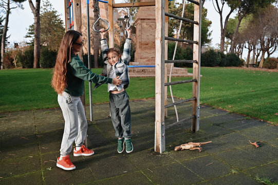 Outdoor playtime adventure on the monkey bars with family