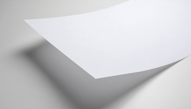 Blank White Paper Sheet Casting a Shadow on a Light Gray Surface.