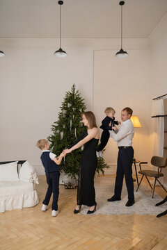 Family celebrating New Year with holiday tree