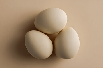 Background texture of three eggs in monochromatic ivory color.
