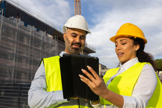 Engineers discussing project plans on construction site