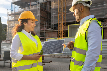 Construction engineers discussing solar panel project