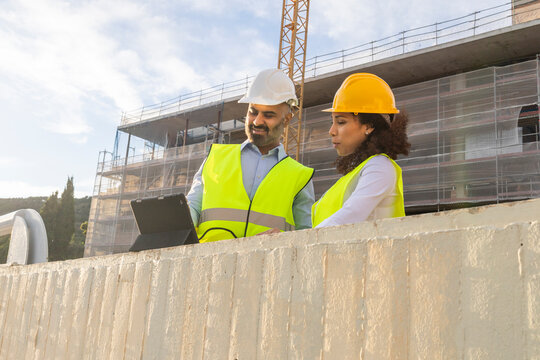 Construction site teamwork with engineers and workers