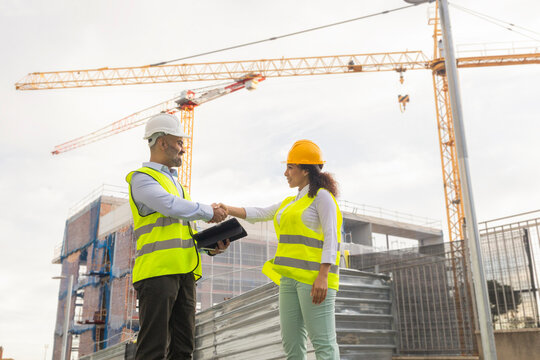 Engineers shaking hands on site