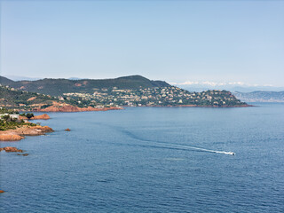 Cliffs on the Cote d'Azur, French Riviera, overlooking Cannes, snow-capped mountains in the background, Drone photo