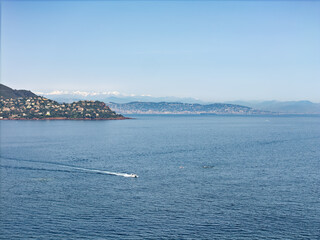 Cliffs on the Cote d'Azur, French Riviera, overlooking Cannes, snow-capped mountains in the background, Drone photo