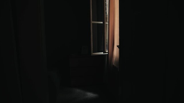 Early in the morning, the window in the dark room is open, and a light, fresh breeze flutters the curtains. The house is quiet and peaceful. High quality 4k footage