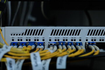 Yellow coiled fiber optic patch cord with blue connectors SFP modules are essential for high-speed data transmission over fiber optic networks.