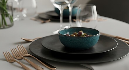 Dark plates with teal bowl of olives and copper cutlery table setting dinnerware