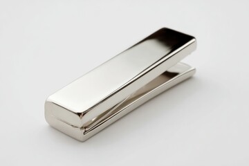Close-up of a sleek silver metal paperweight on a white background