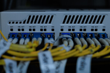 Yellow coiled fiber optic patch cord with blue connectors SFP modules are essential for high-speed...