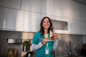 Healthcare worker taking sandwich break in kitchen