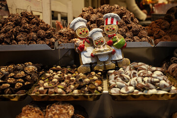 Festive chocolate display with gingerbread figures and assorted pralines in a traditional shop during Christmas in Bruges