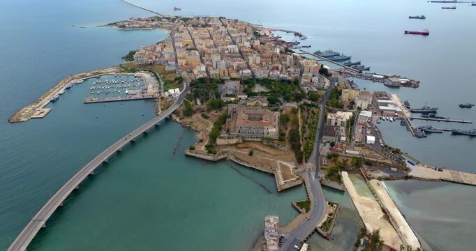 Aerial view of the town of Augusta, in the province of Syracuse, Sicily, Italy. The historic centre is built on an island overlooking the Mediterranean Sea. In the foreground is the Swabian castle.
