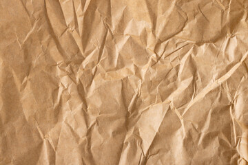 Close-up macro view of a wrinkled brown paper surface,Brown crumpled paper page macro close up view,brown wrinkled paper texture and background. top view