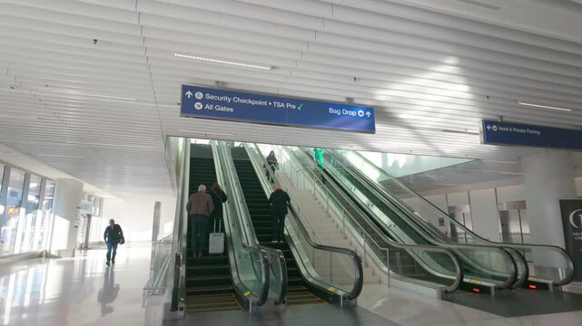 Los Angeles, California, USA. December 06, 2025: Travelers navigate escalators in the modernized Delta Sky Way terminal at LAX, showcasing its sleek architecture and efficient passenger services