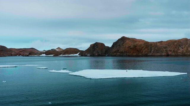 Small Boat Sailing in Front of Mountains at Sunrise. Antarctica