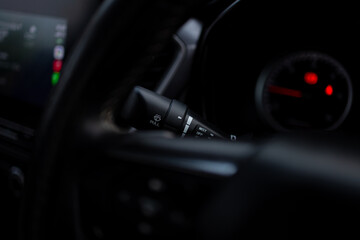 Fototapeta premium Remote control button for car windshield wipers,Windshield wiper switch in the car,Car windshield wiper switch. Wipers switch control. Adjusting speed wipers in car. 