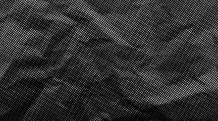 Fotobehang Pop Art Halftone crumpled paper texture with wite a dotted, rough, and wrinkled surface. Black creased sheet background in comic pop-art style, featuring grainy folds and gritty distressed details.  © Maryna