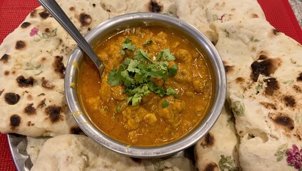 Authentic indian dal curry served with naan flatbread