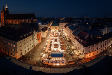 Christmas market with illuminated stalls at night on the Small Market Square in Krakow, Poland