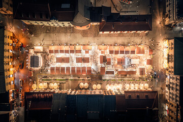 Christmas market with illuminated stalls at night on the Small Market Square in Krakow, Poland
