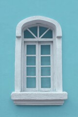 Brighten up your space with a white window frame against a blue backdrop.