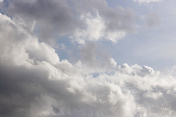 Obraz premium Dynamic Cloudscape with White and Gray Formations. Cloudscape Background. Nature and Climate Concept. High quality photo