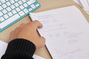  close up of hand pointing on a paper with mathematics equations, studying mathematics