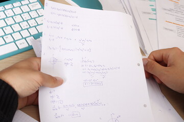 close up of hand pointing on a paper with mathematics equations, studying mathematics