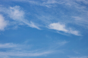 Fototapeta premium Expansive Blue Sky with Delicate Cirrus Clouds. Daylight sky background. cloudscape atmosphere. Climate and Nature Concept. High quality photo