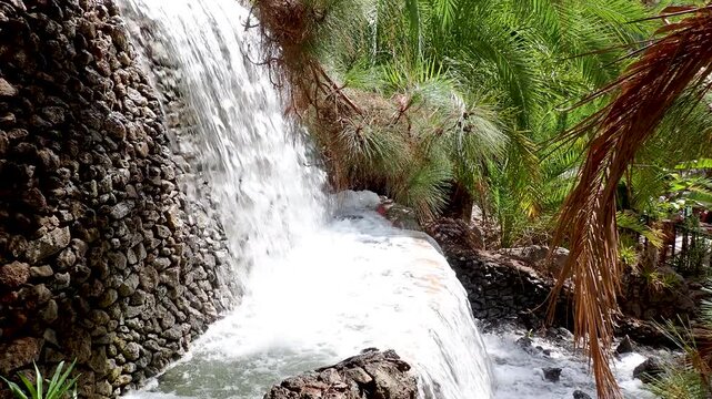 Small cascades in Palmitos Park in Gran Canaria, Spain. Renowned zoo, botanical garden famous for its tropical oasis, animal shows, dolphins, parrots, birds of prey, aquarium, and diverse wildlife. 