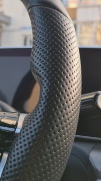 Premium perforated leather texture on a car steering wheel