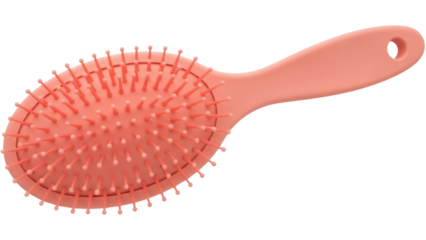 Isolated pink oval hairbrush with flexible plastic bristles for detangling & styling hair