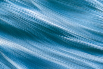 abstract blue background closeup of flowing, moving water