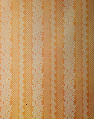 Old wallpaper on the wall. Old wallpaper for texture or background.