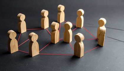 Obraz premium Wooden peg people connected by red strings representing social networking team collaboration and professional community links