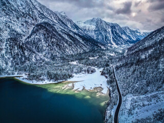 Winter magic in the Julian Alps. Lake Predil seen from above. Between snow and ice.